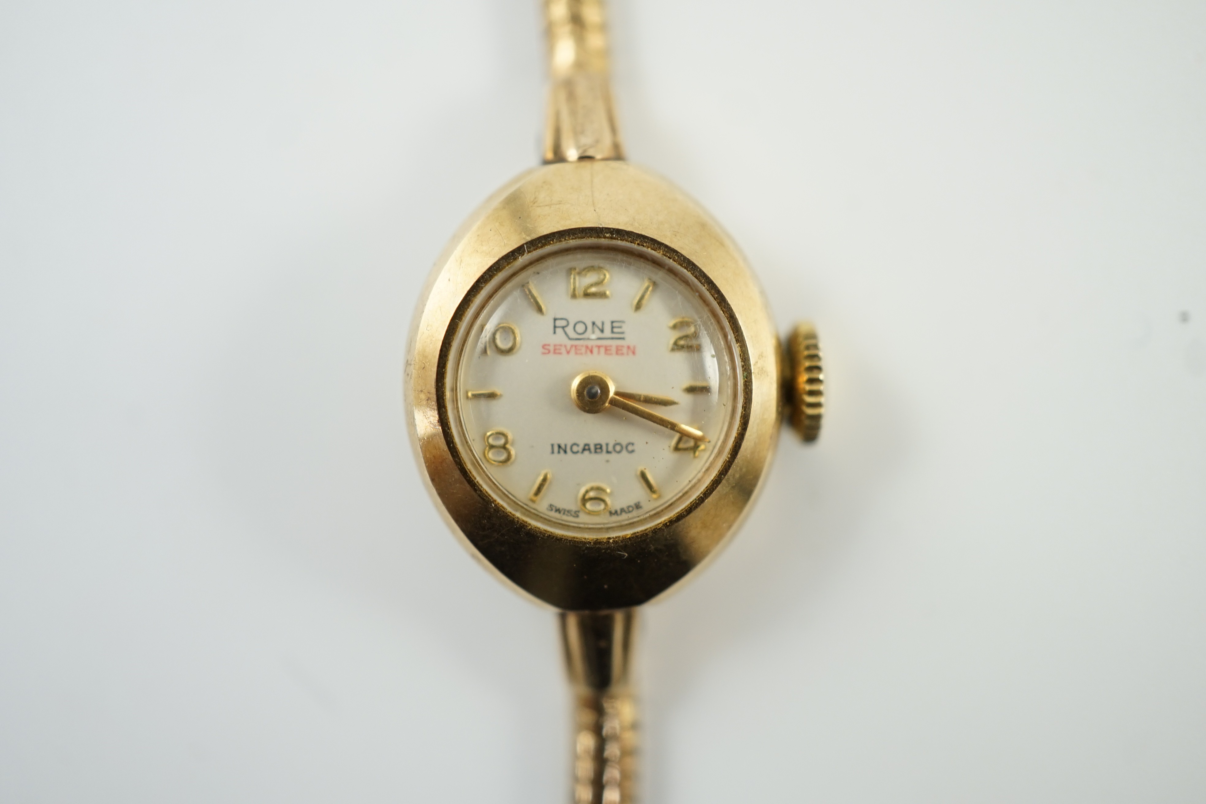 A lady's modern 9ct gold Rone manual wind wrist watch, on a 9ct gold snake link bracelet, overall 16.cm, gross 11.3 grams.